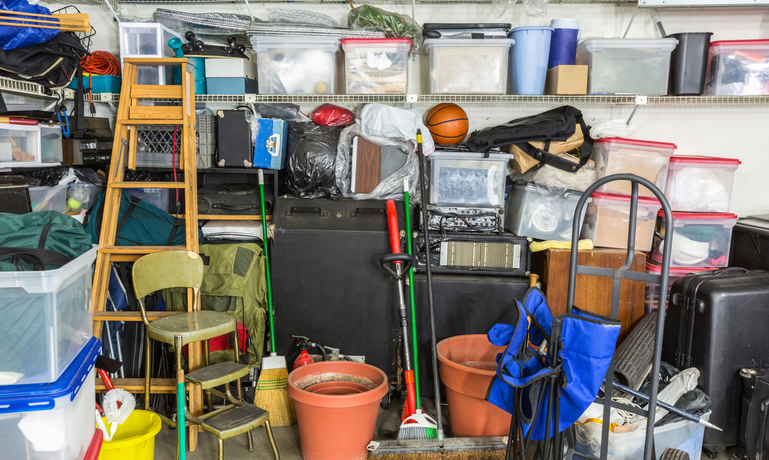 A messy garage full of items ready for the Junk Force team to clean out